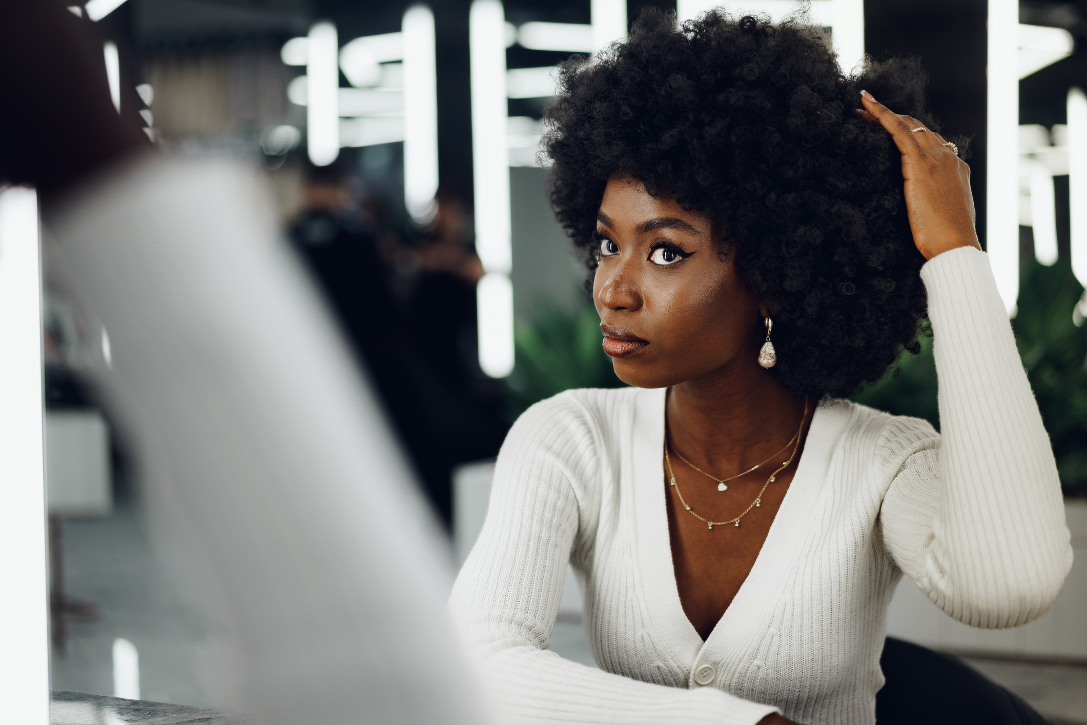 Young african woman customer getting a hairstyle at a beauty salon.